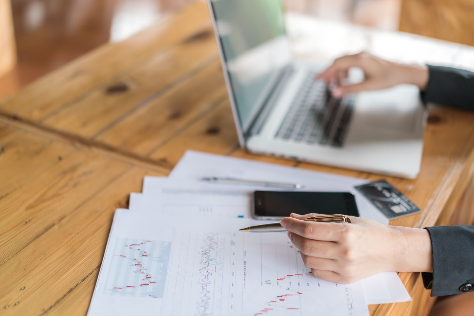 Woman hand with financial charts