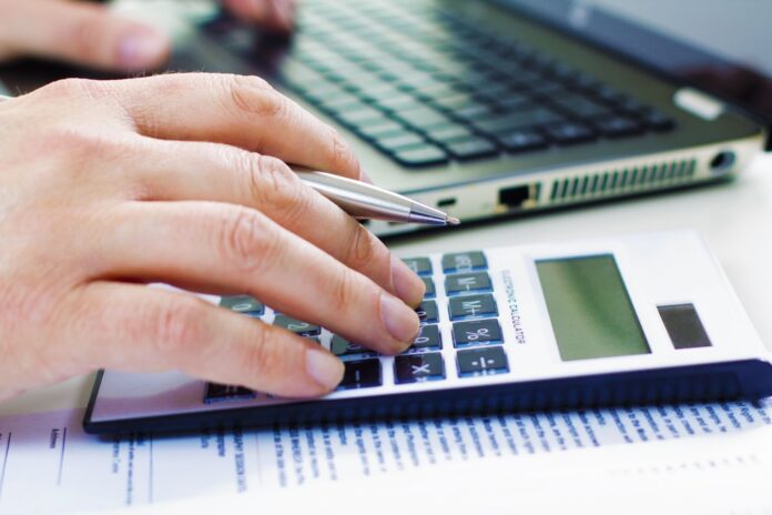 Man counting on a calculator